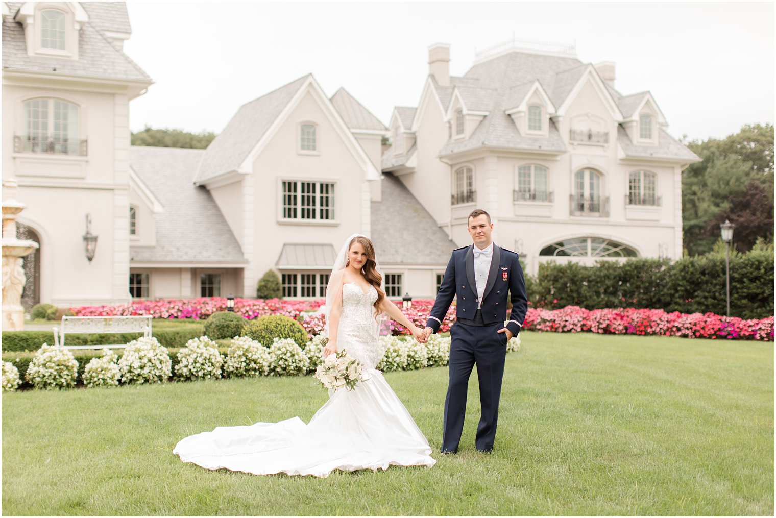 newlyweds pose on lawn at Park Chateau Estate