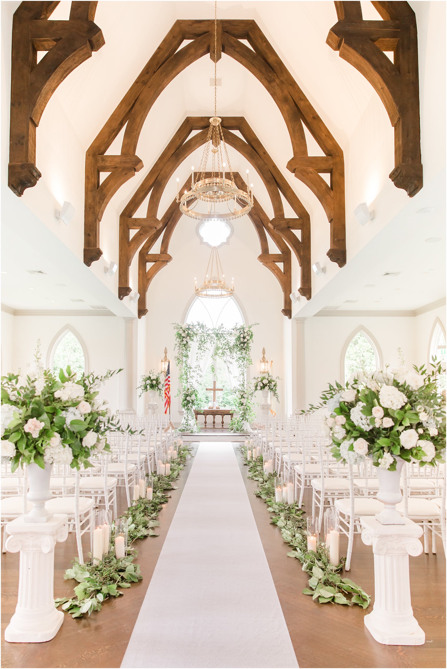 East Brunswick NJ wedding ceremony in chapel with greenery and white flowers 