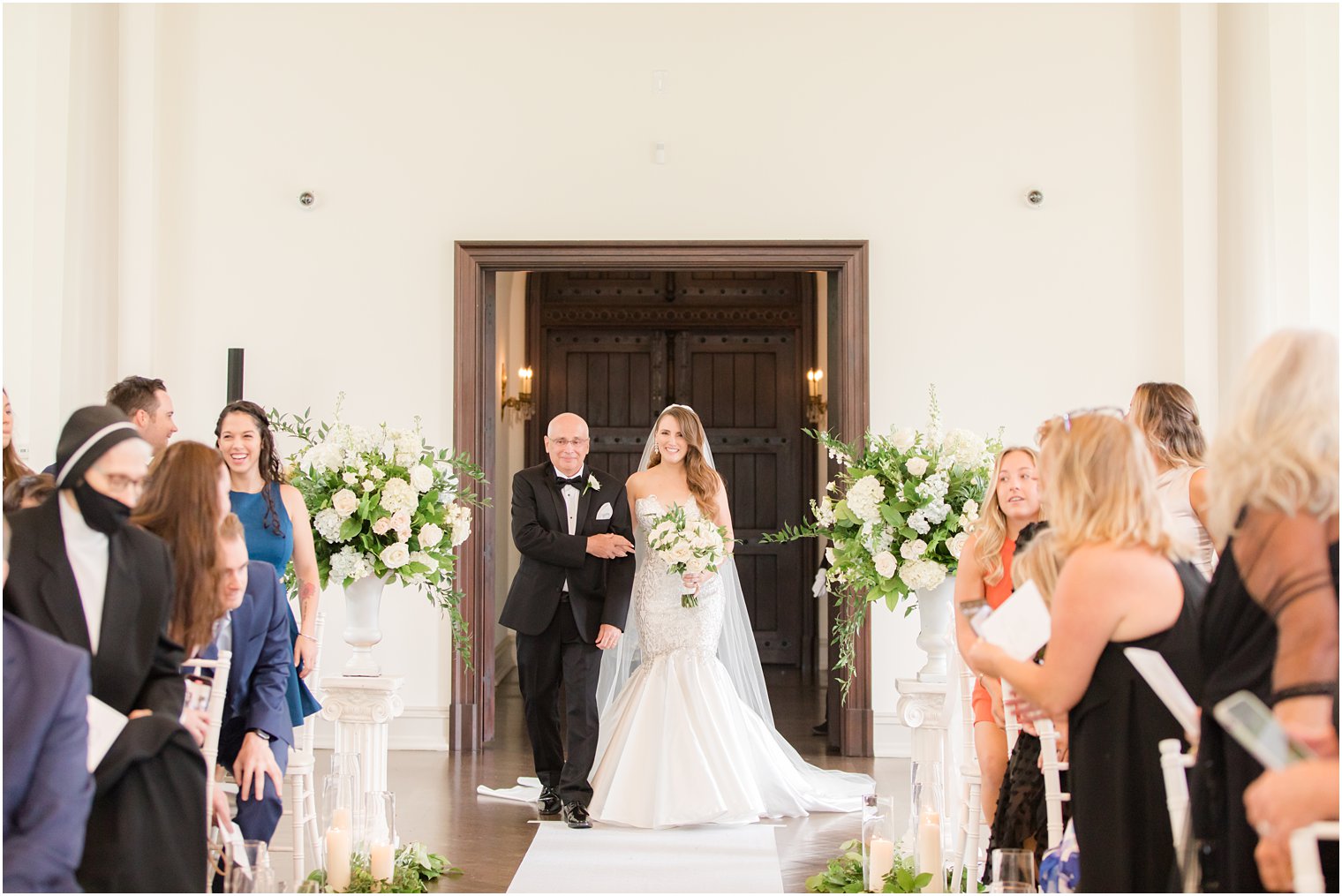 bride enters East Brunswick NJ wedding ceremony in chapel