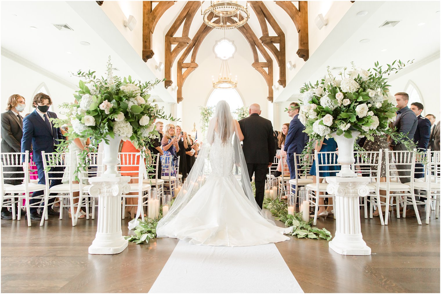 bride walks down the aisle with dad at East Brunswick NJ wedding ceremony in chapel