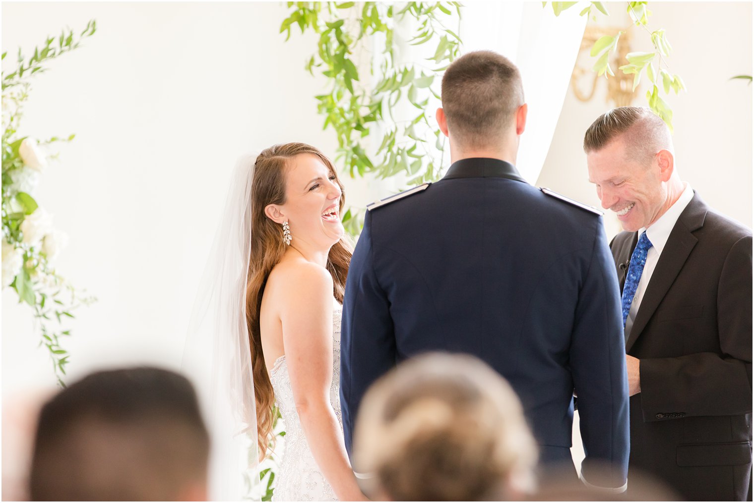 bride laughs at groom during East Brunswick NJ wedding ceremony in chapel