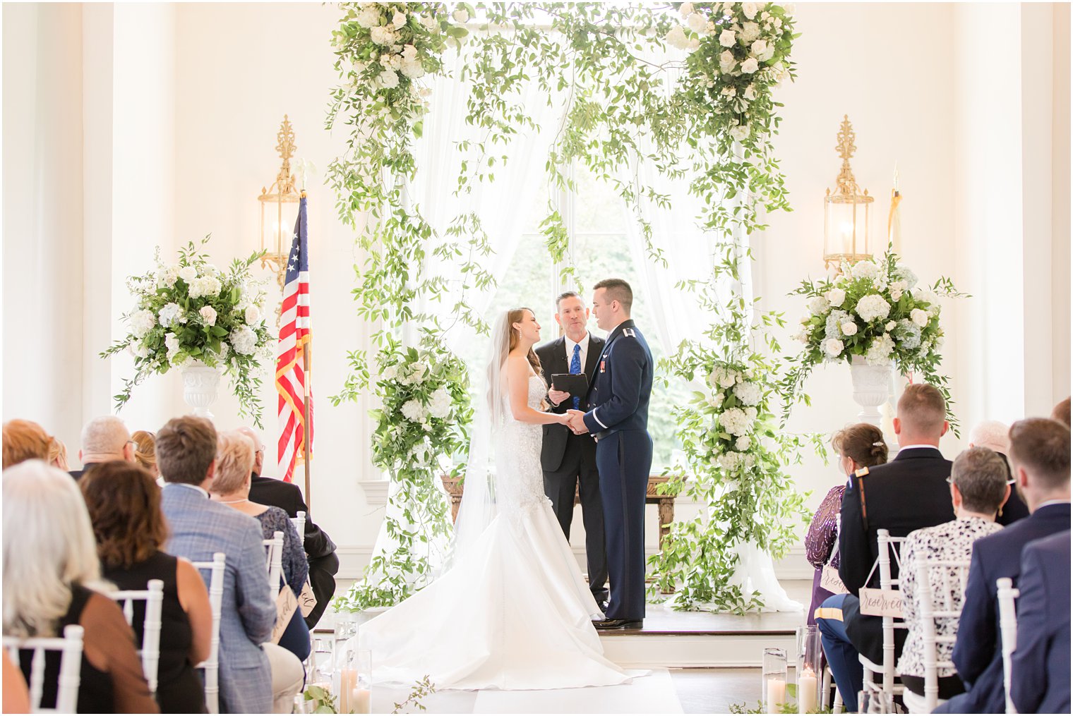 bride and groom hold hands during East Brunswick NJ wedding ceremony in chapel