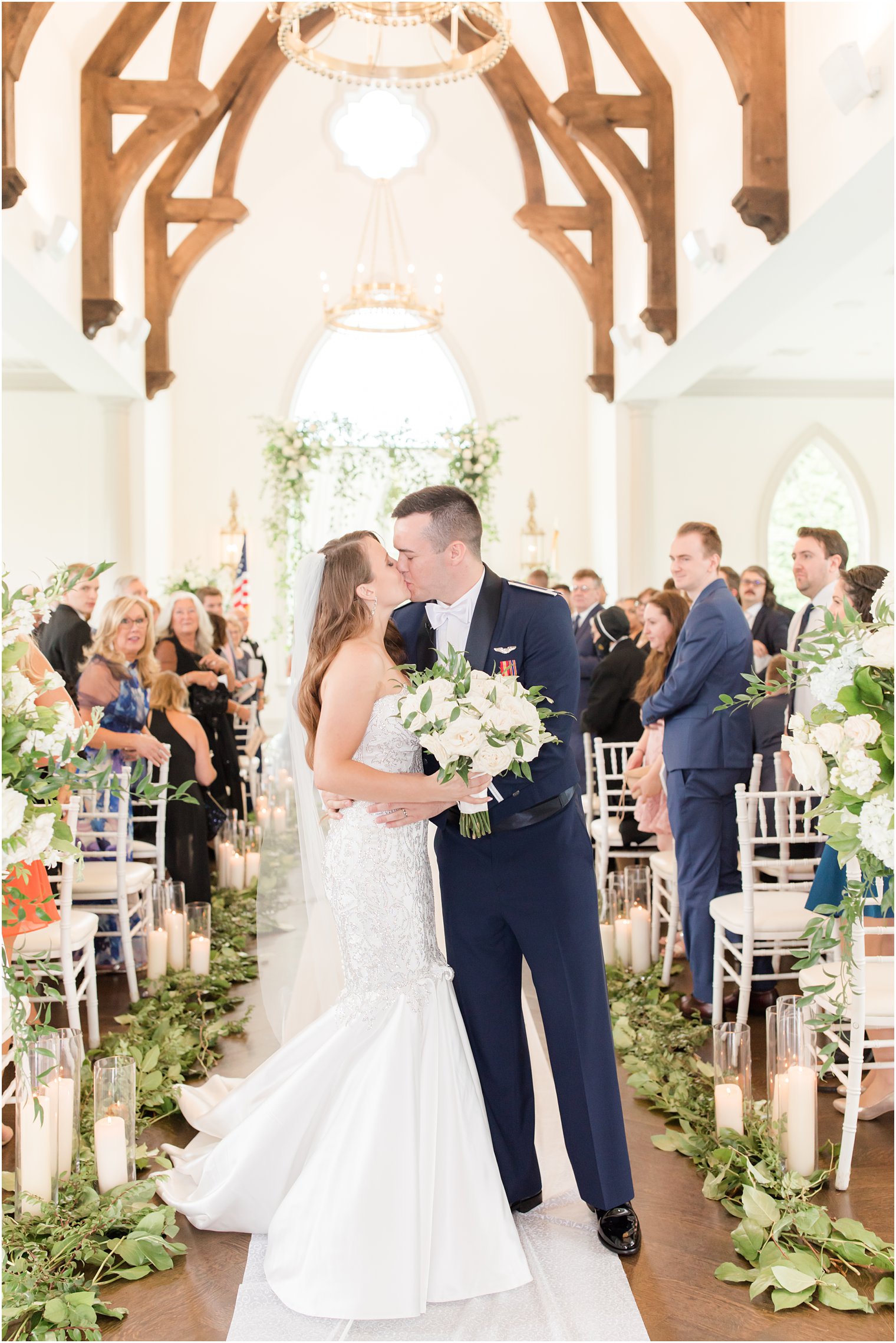 bride and groom kiss at the end of the aisle at the chapel at Park Chateau Estate