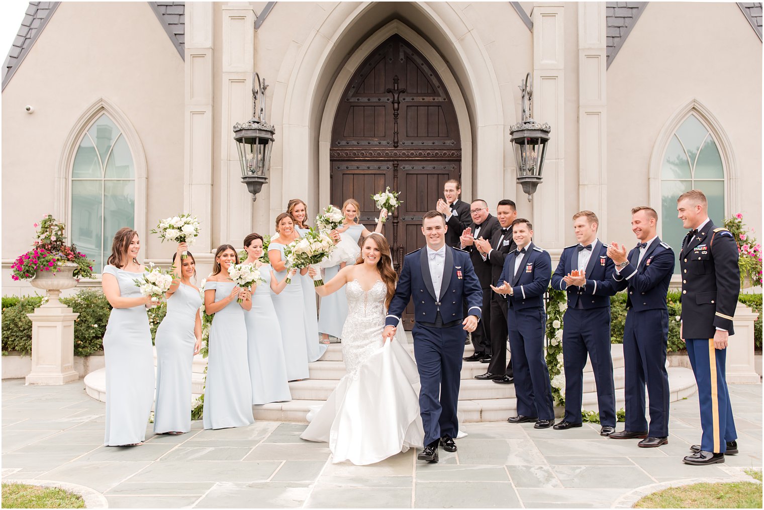 newlyweds walk outside chapel at Park Chateau Estate with wedding party 