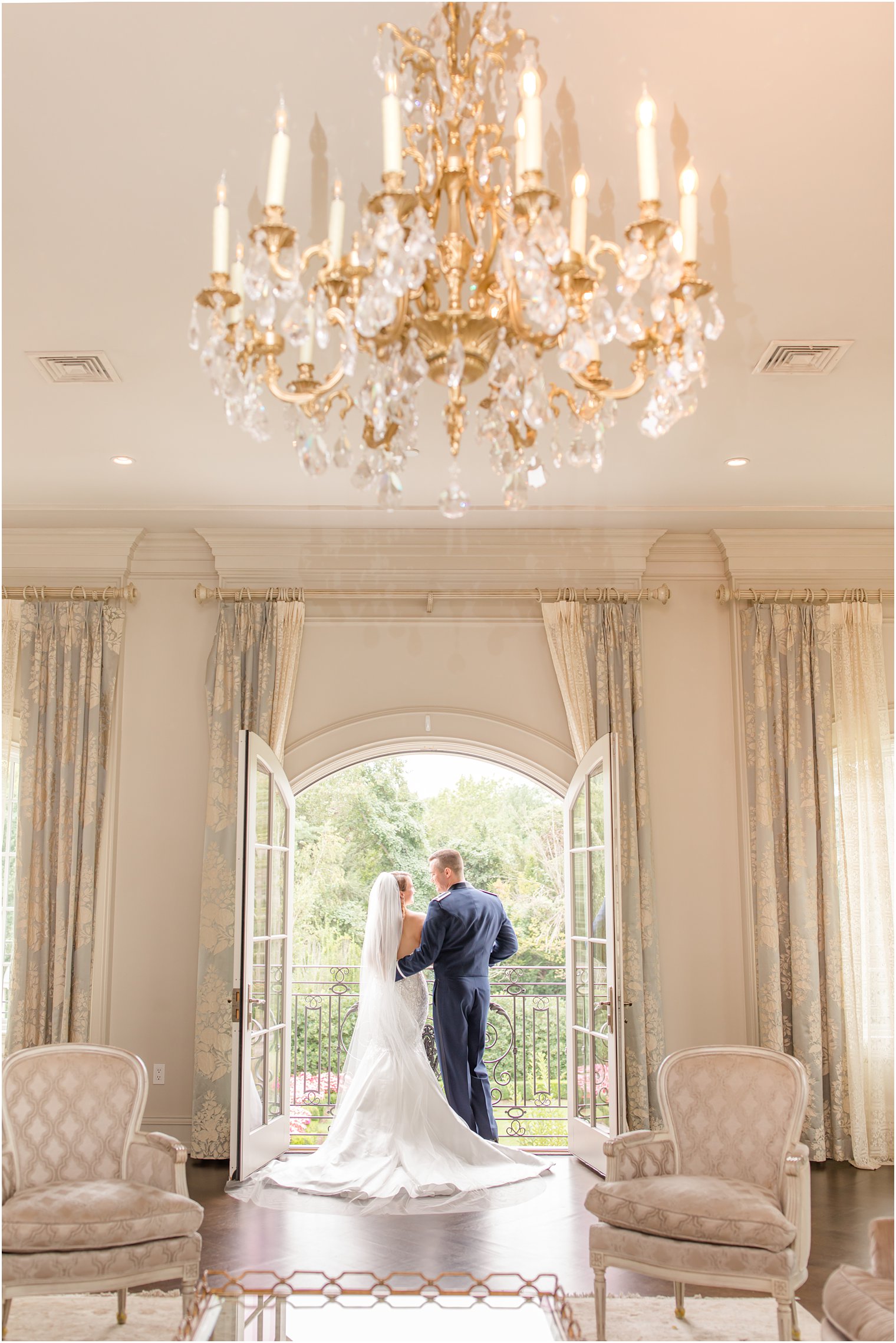 bride and groom pose on balcony of bridal suite at Park Chateau Estate