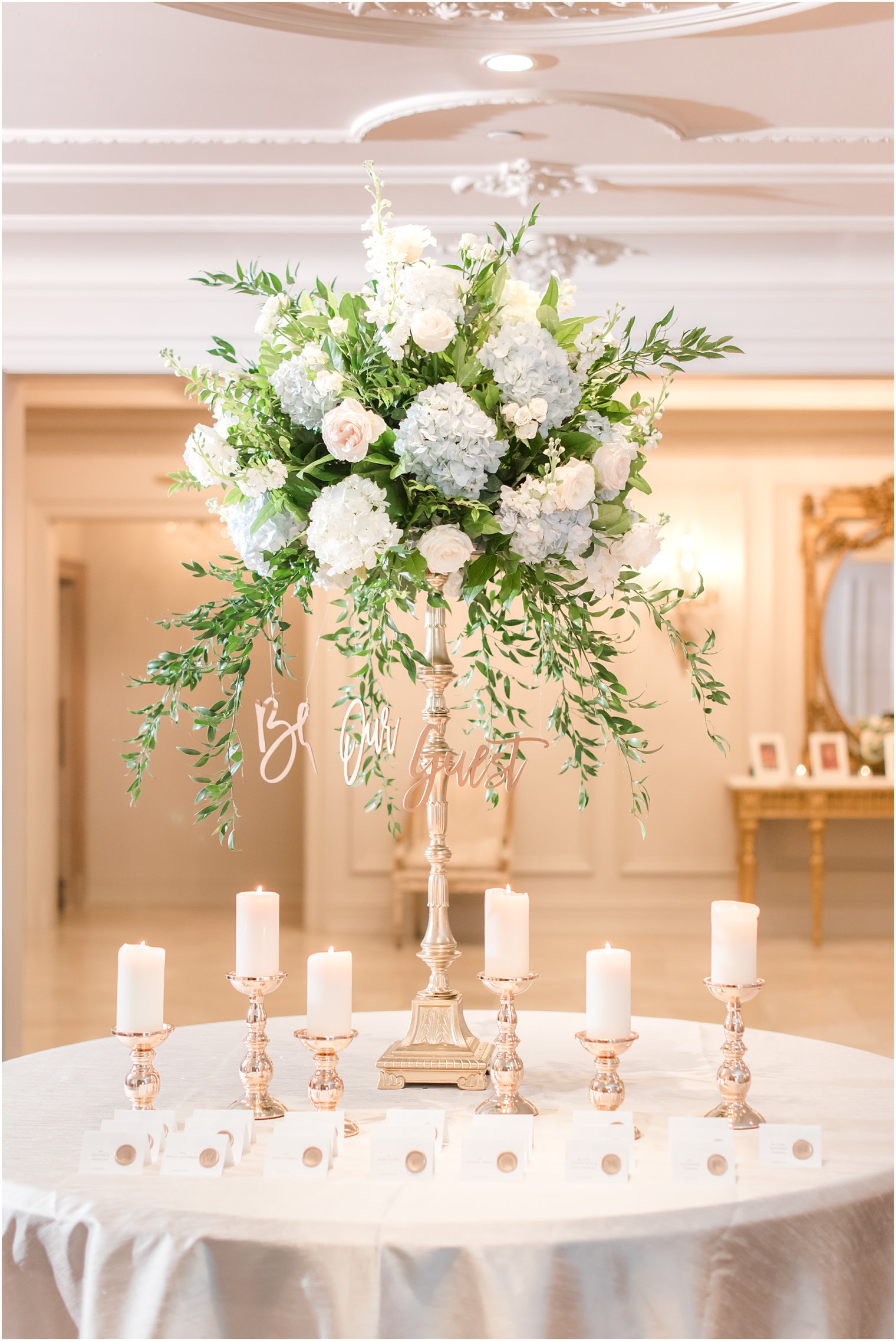 escort cards with tall floral centerpiece at Park Chateau Estate