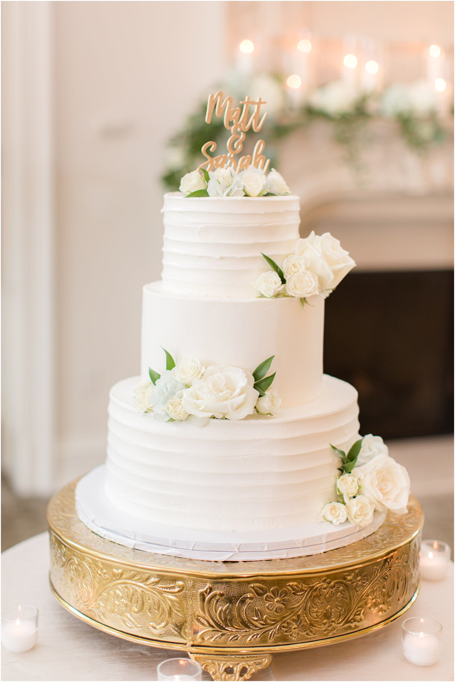 tiered wedding cake with white flower accents