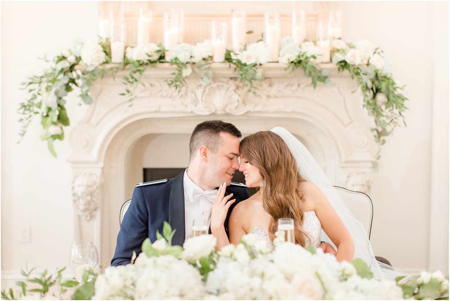 bride and groom sit at sweetheart table during East Brunswick NJ wedding reception