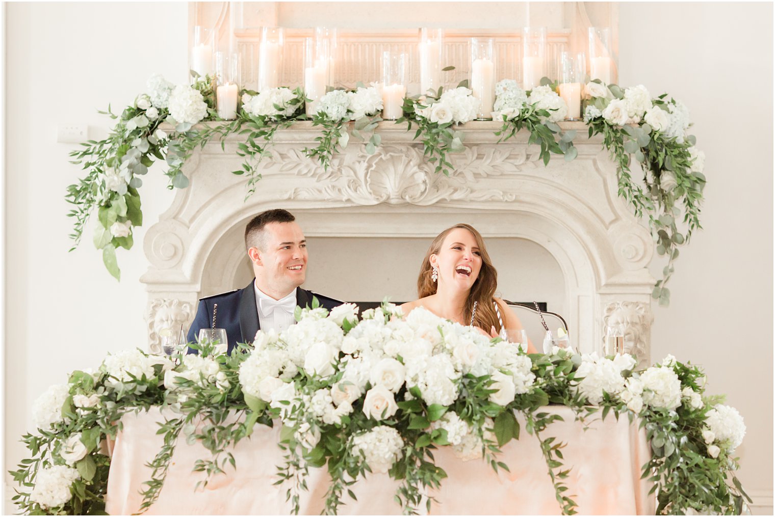 newlyweds laugh at sweetheart table at Park Chateau Estate 