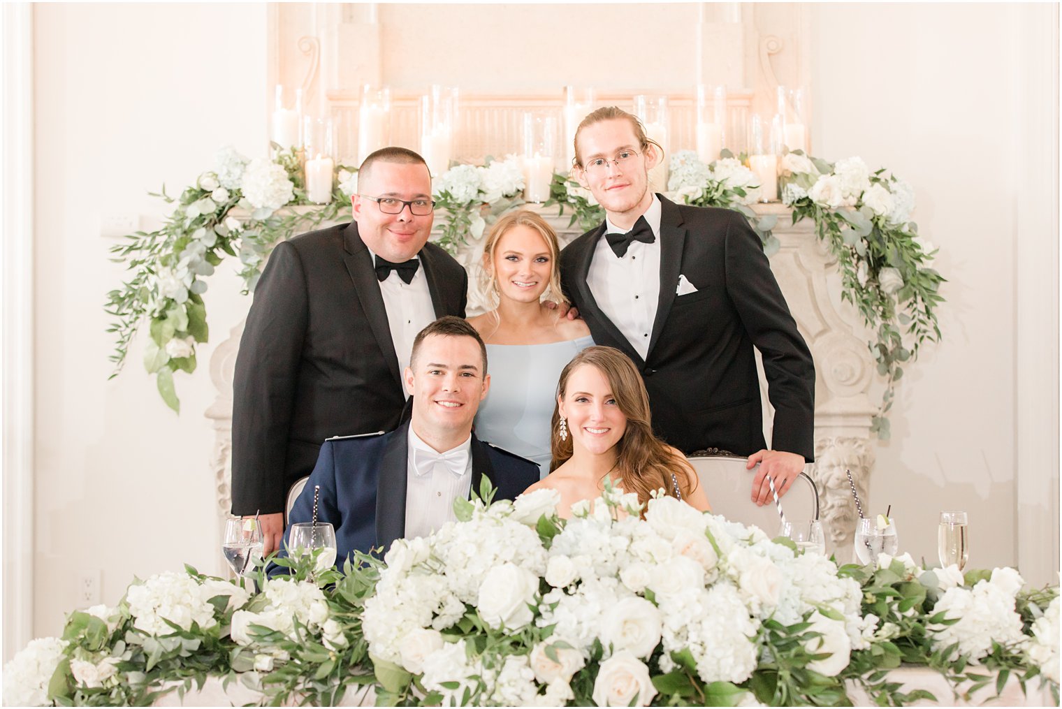 bride and groom pose with wedding party during East Brunswick NJ wedding reception