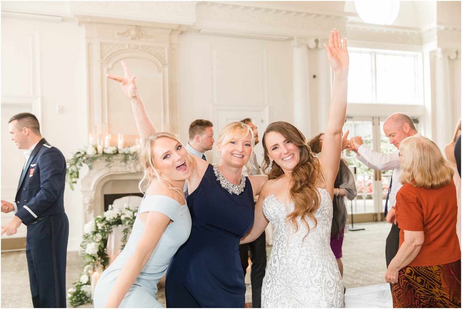 bride poses with two guests during East Brunswick NJ wedding reception