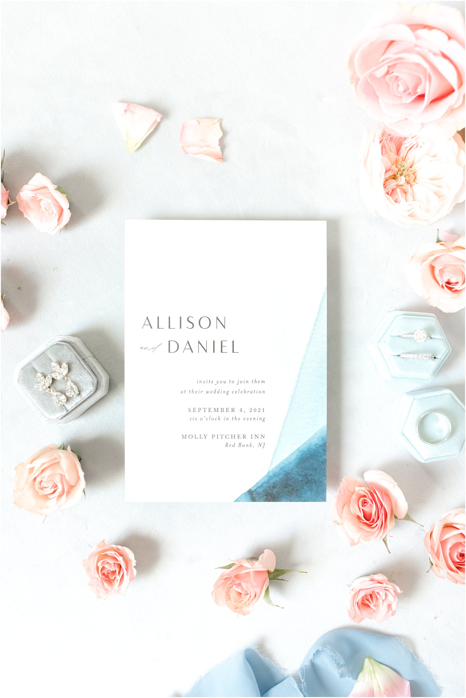 wedding invitation with pink and blue details around it