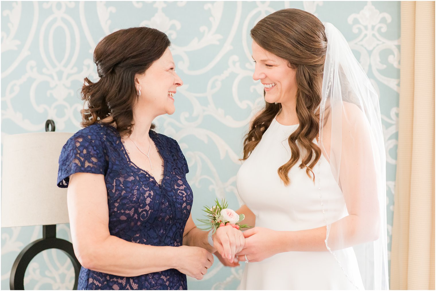 bride helps mom with wrist corsage for wedding day at Molly Pitcher Inn