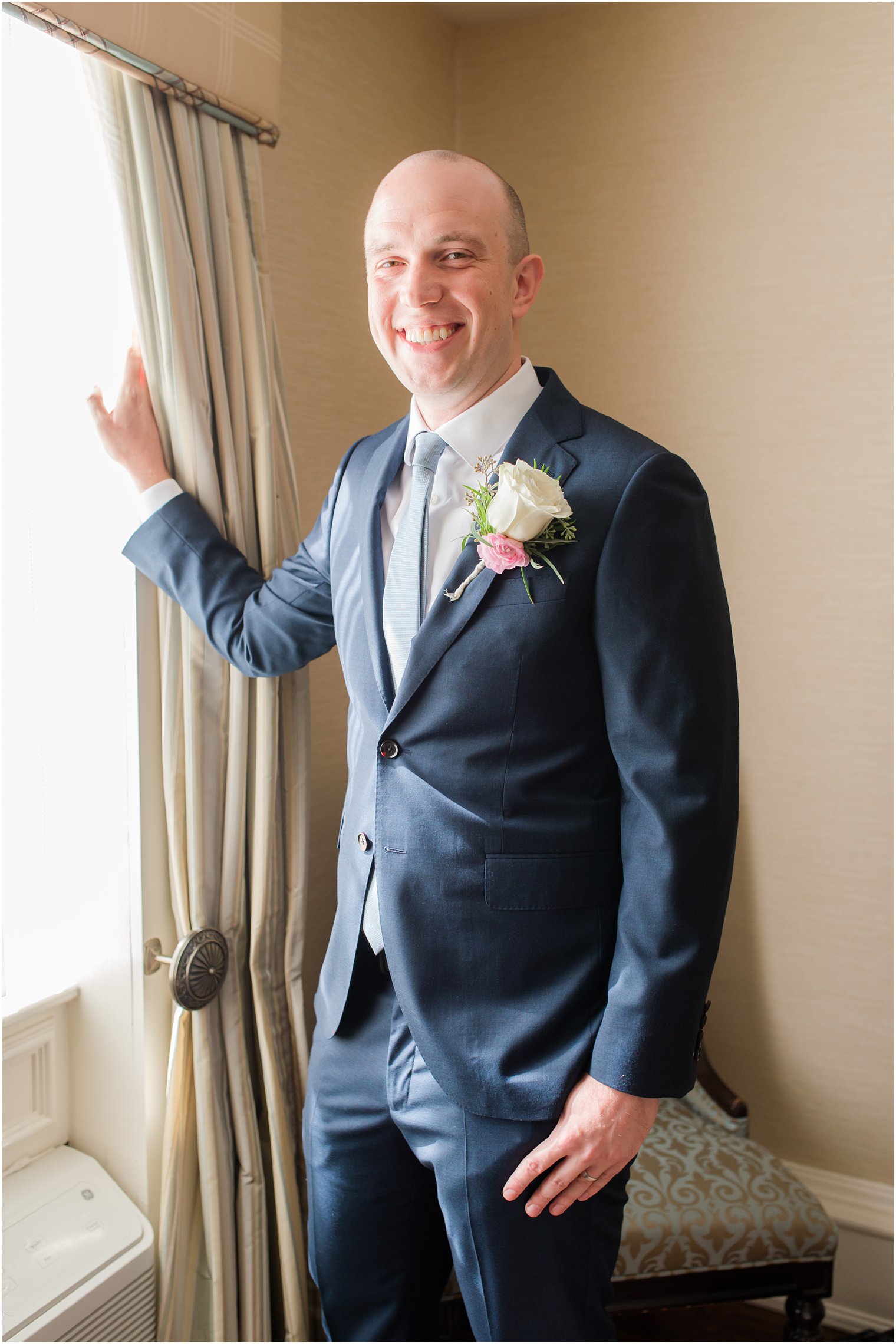 groom in navy tux prepares for vow renewal at Molly Pitcher Inn