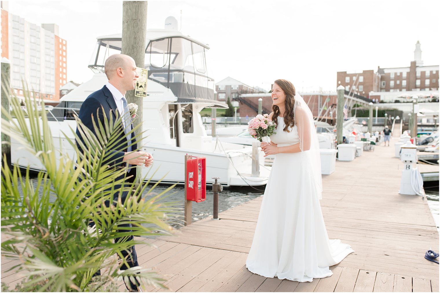groom approaches bride for first look on dock 