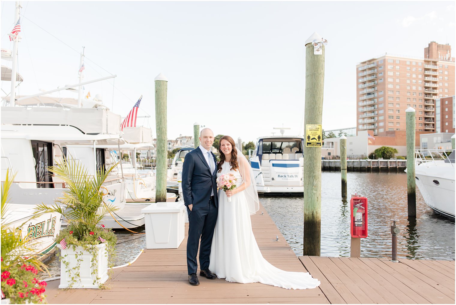 bride and groom stand on dock at Molly Pitcher Inn