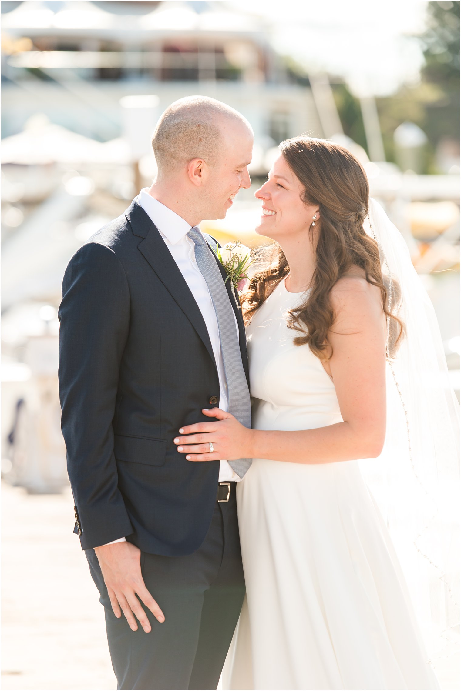 bride and groom stand together on marina at Molly Pitcher Inn