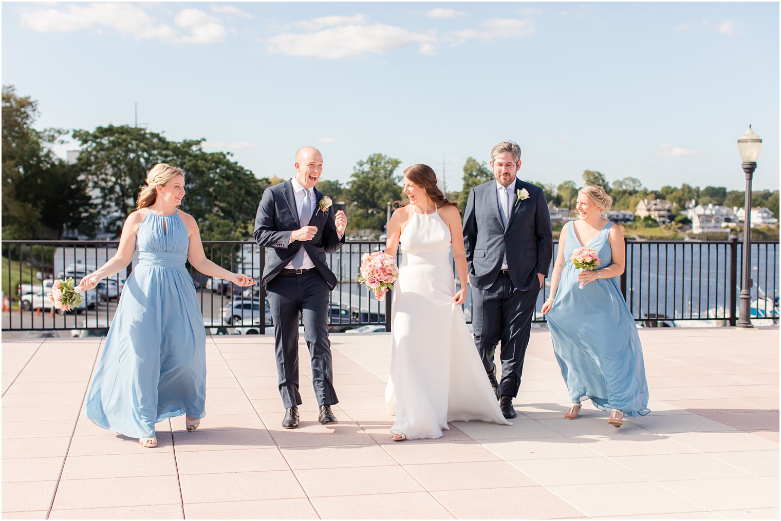couple walks with wedding party outside Molly Pitcher Inn
