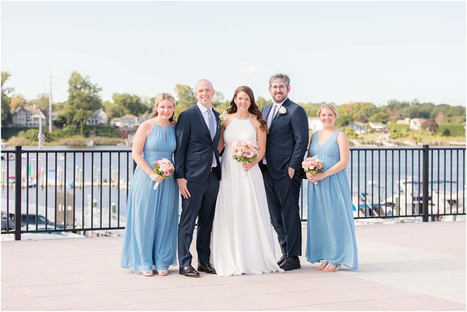 bride and groom pose with small wedding party 