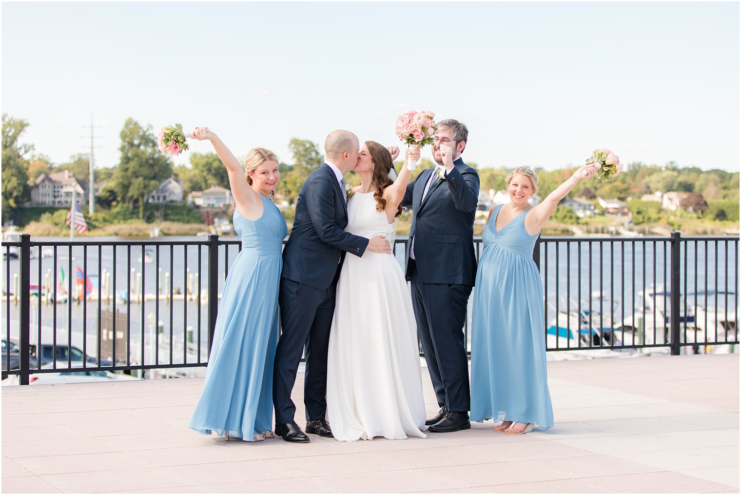 wedding party cheers while couple kisses at Molly Pitcher Inn