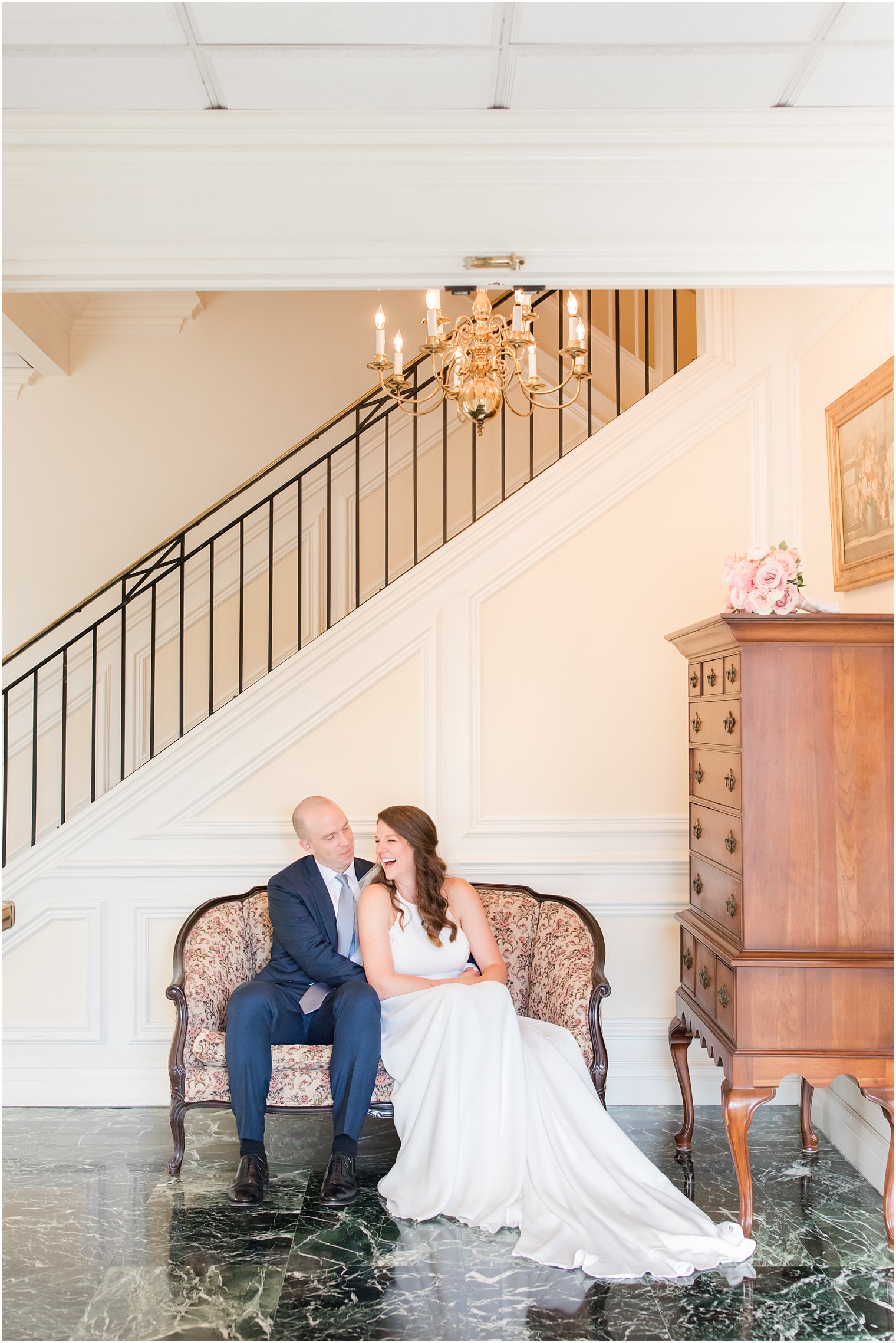 bride and groom laugh in the lobby of Molly Pitcher Inn