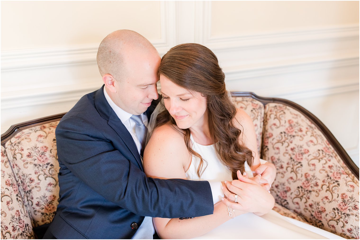 couple hugs sitting on couch at Molly Pitcher Inn