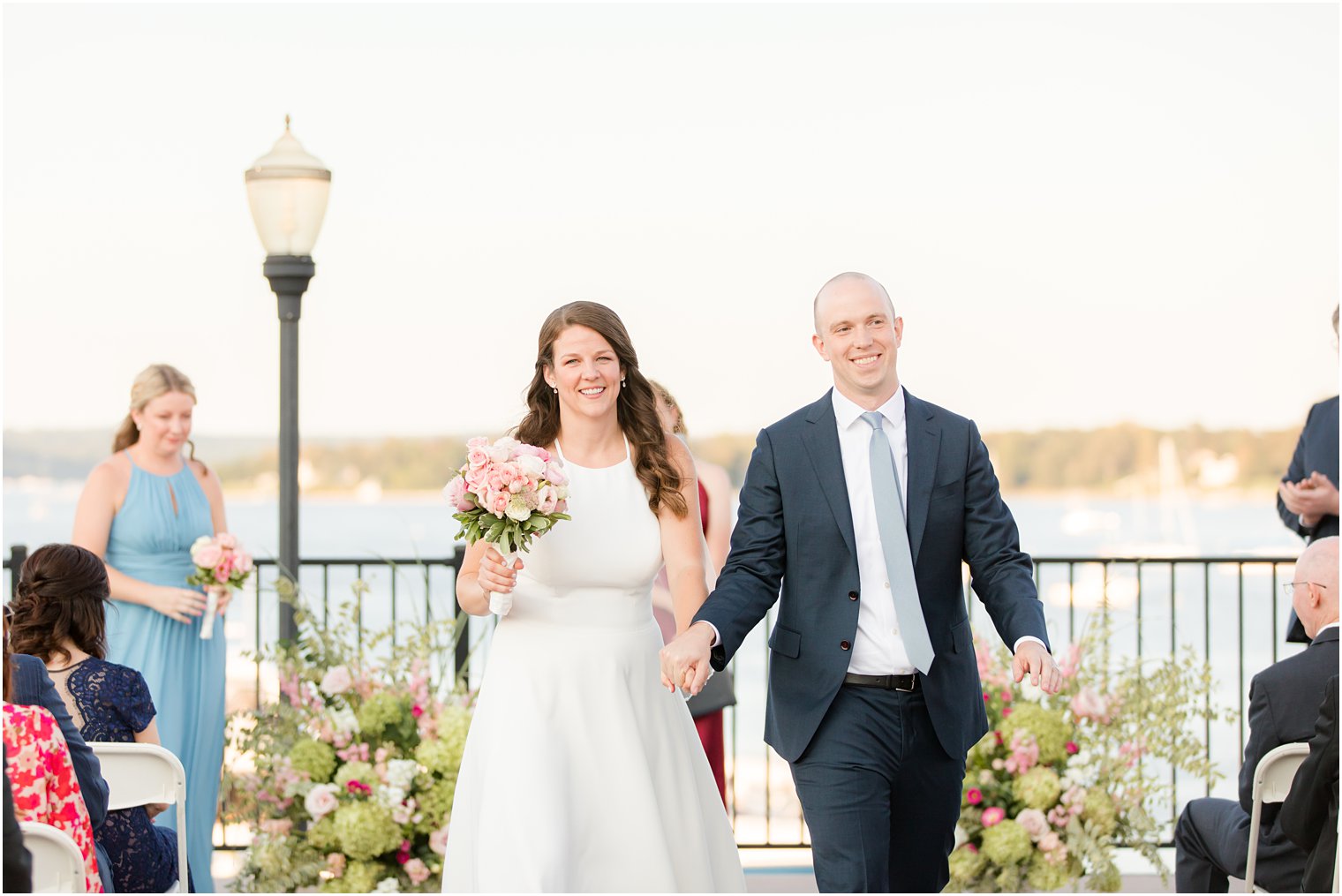 newlyweds leave outdoor waterfront wedding ceremony in Red Bank NJ