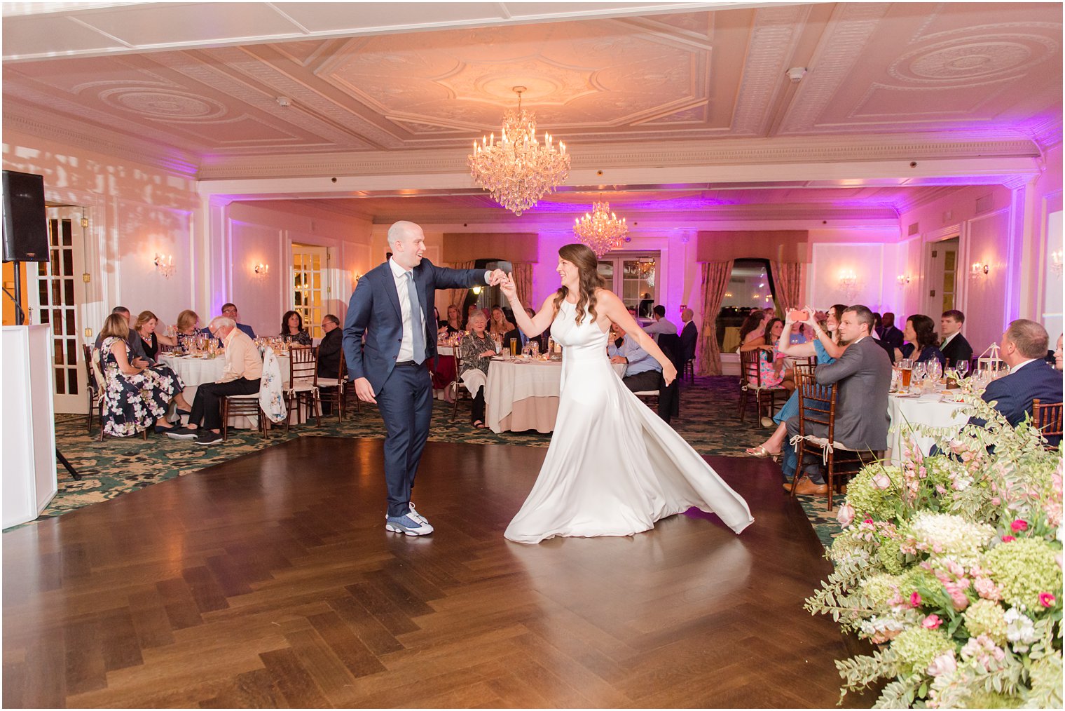 groom twirls bride on dance floor for first dance at Red Bank NJ wedding reception