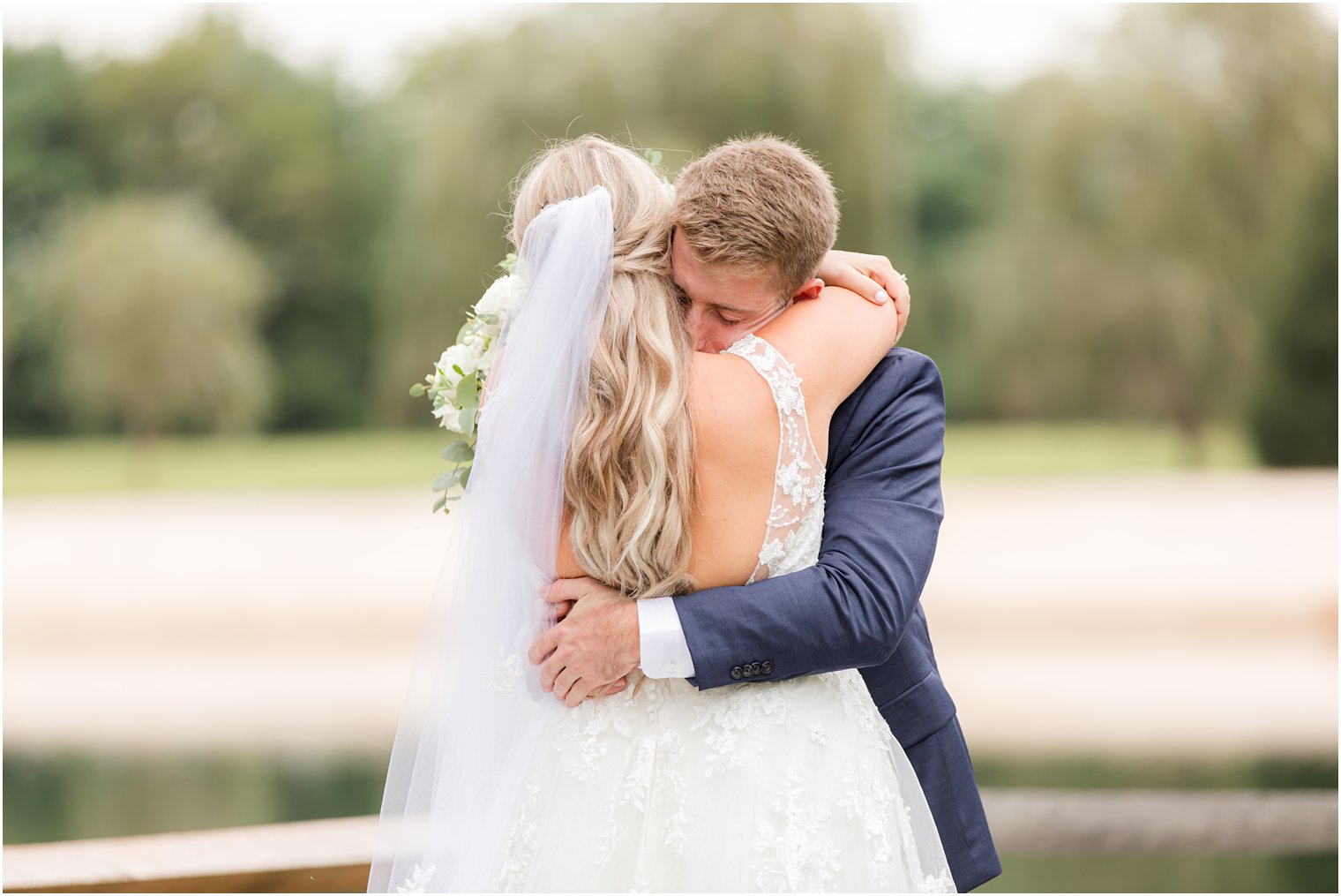 bride hugs groom during first look on wedding day