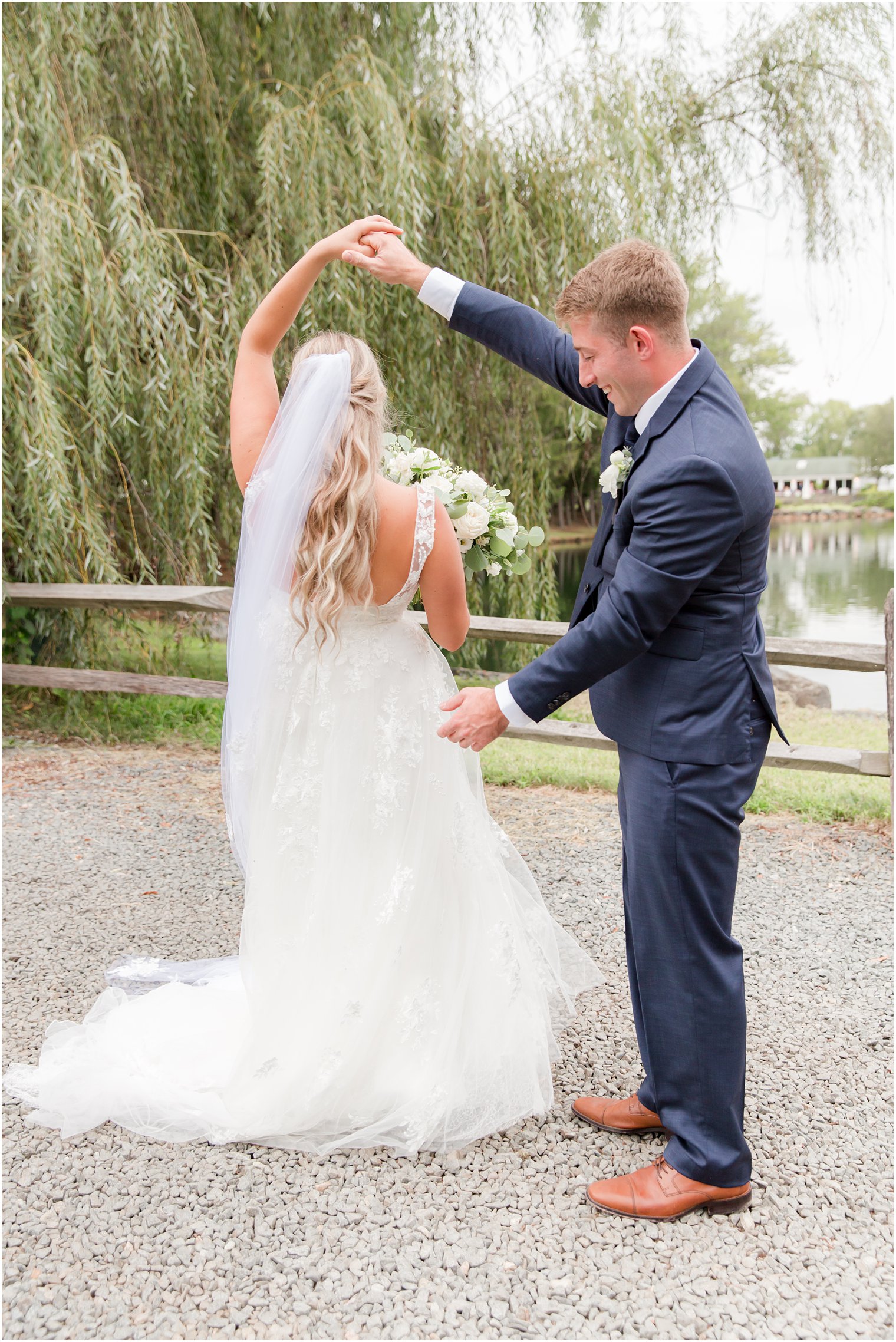 bride twirls in wedding gown during first look