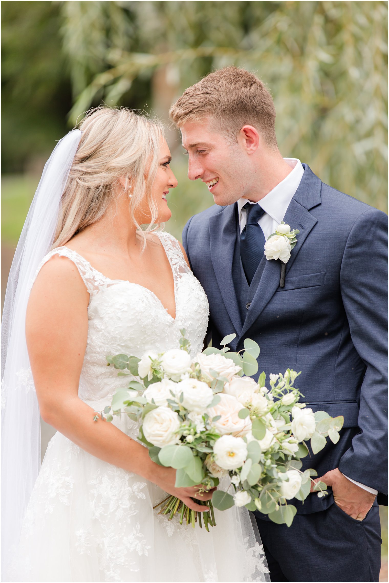 newlyweds smile laughing together at Windows on the Water at Frogbridge