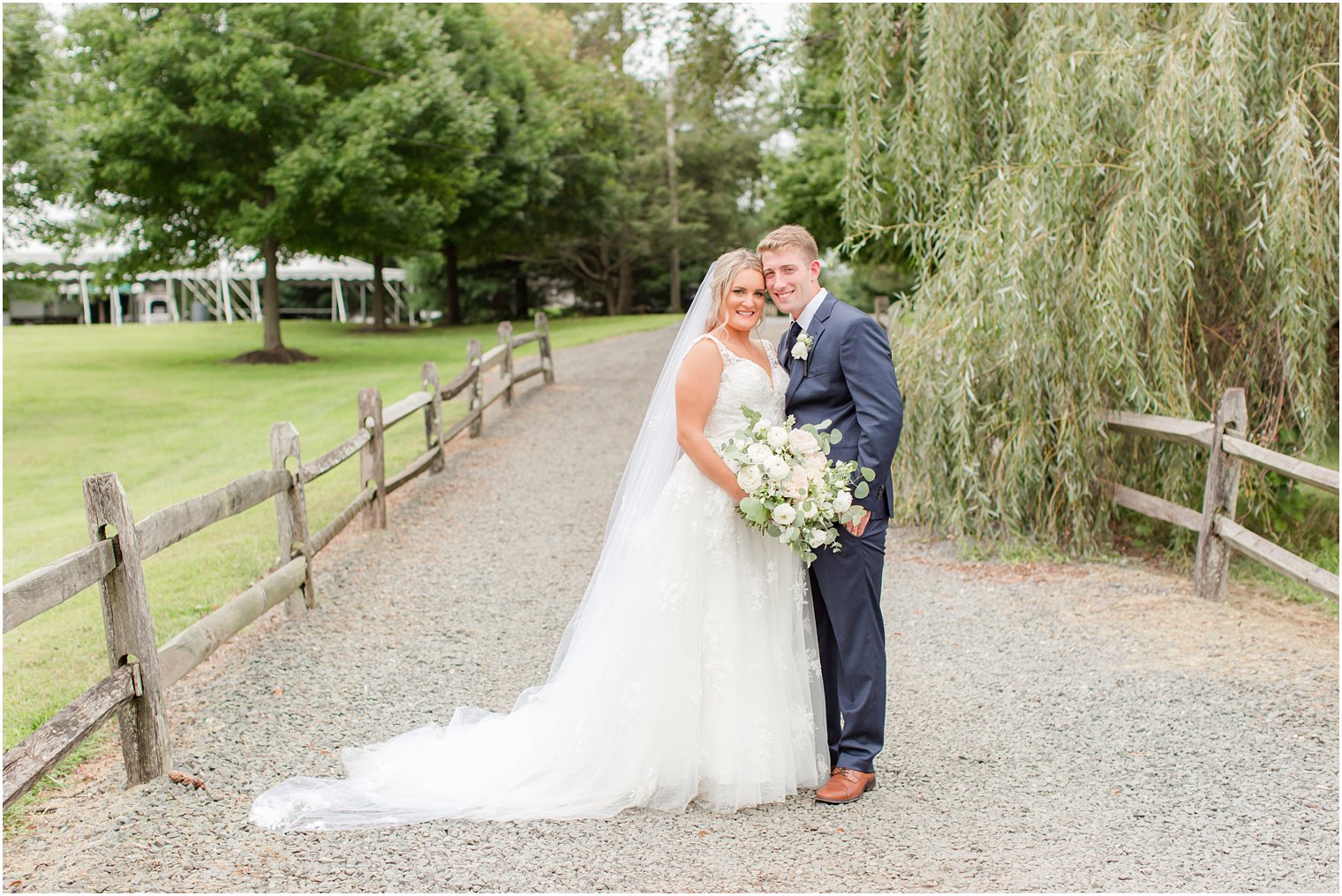 bride and groom lean heads together at Windows on the Water at Frogbridge