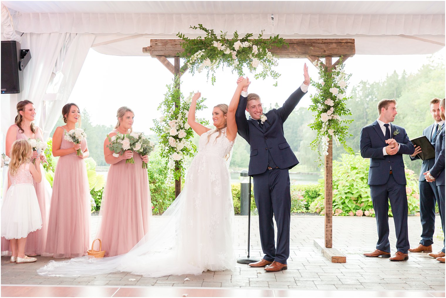 newlyweds cheer after wedding ceremony 