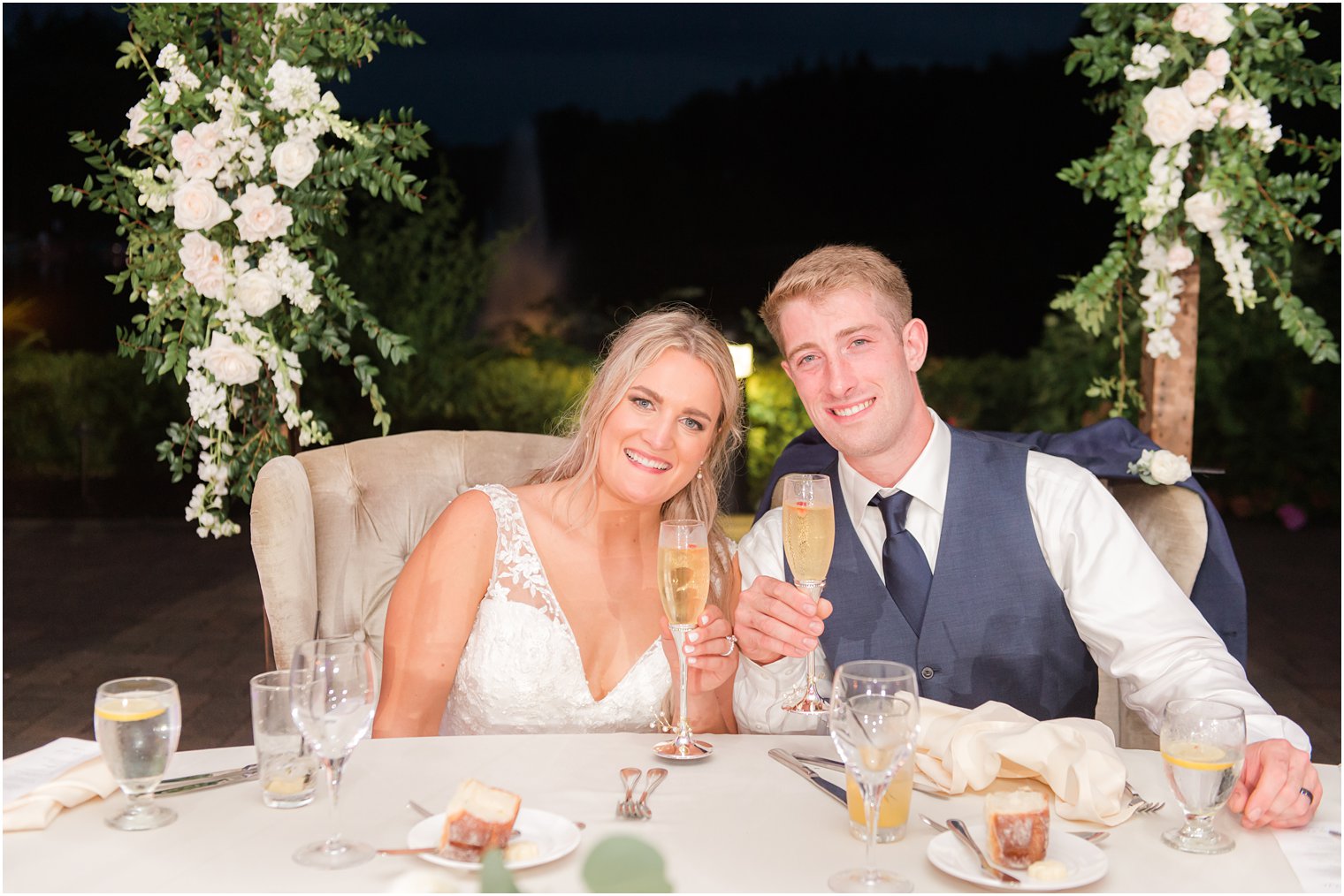 newlyweds toast champagne during Windows on the Water at Frogbridge Wedding reception