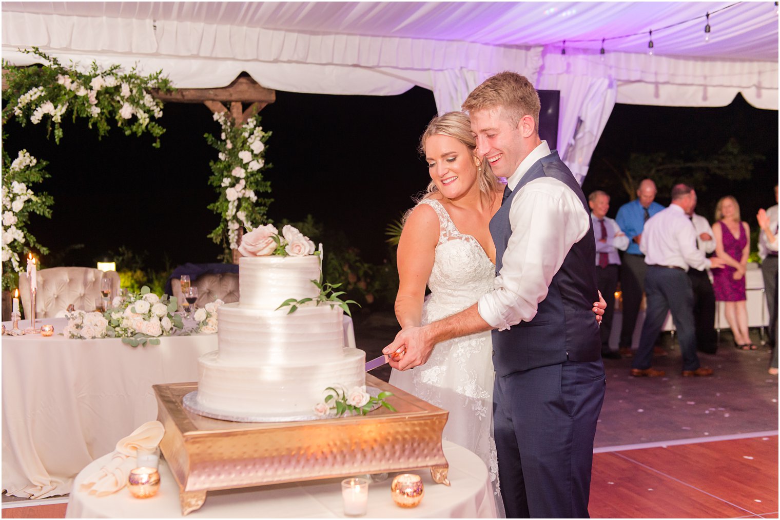 newlyweds cut wedding cake during Windows on the Water at Frogbridge Wedding reception