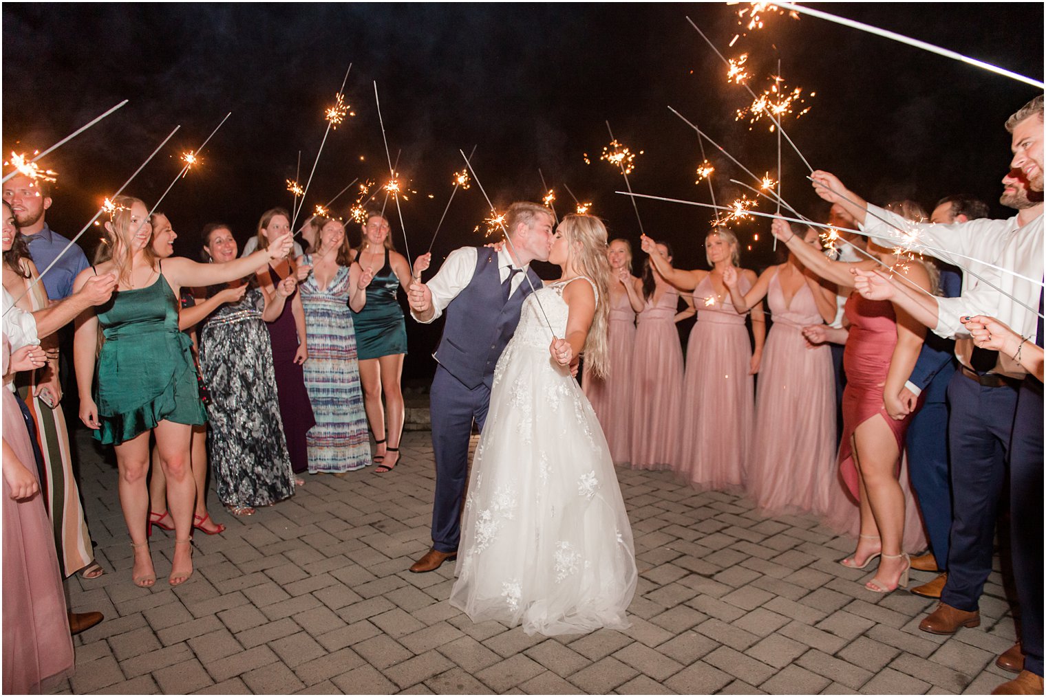 bride and groom kiss during sparkler exit 
