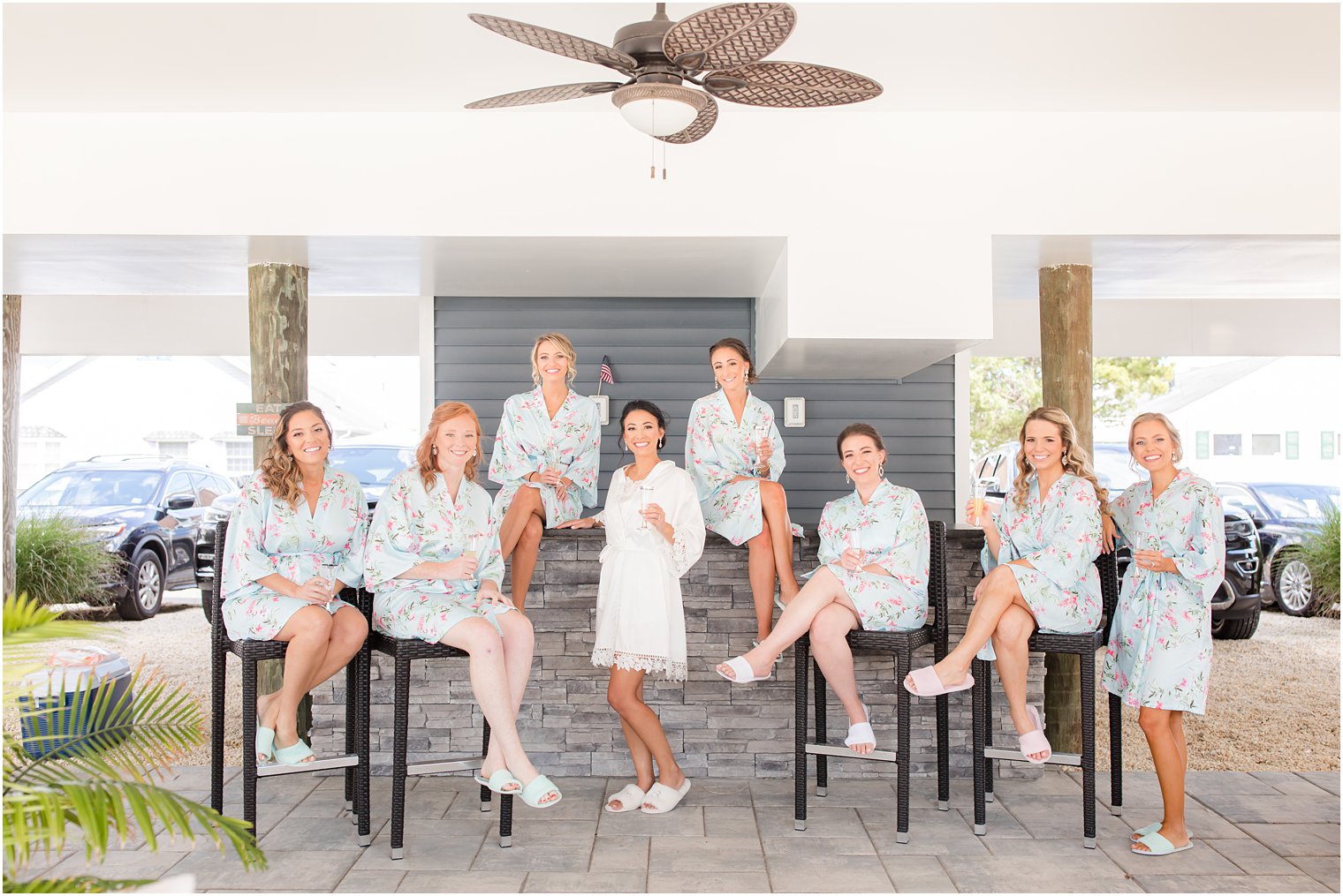 bride sits with bridesmaids before NJ wedding day