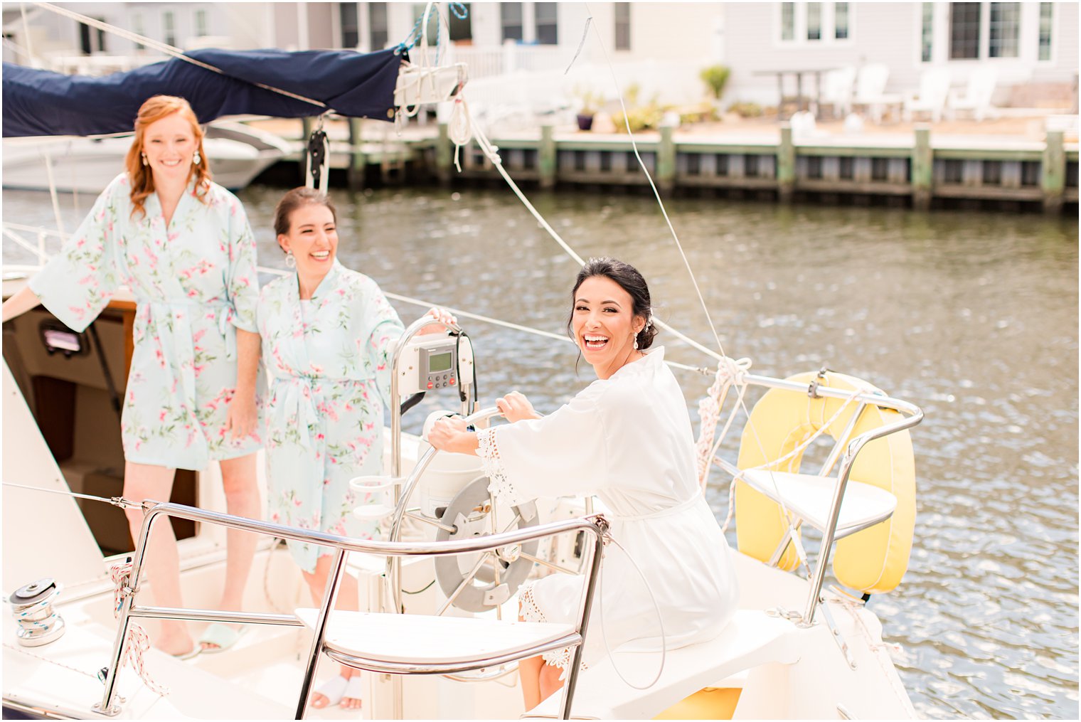 bride and bridesmaids pose on yacht outside Clarks Landing