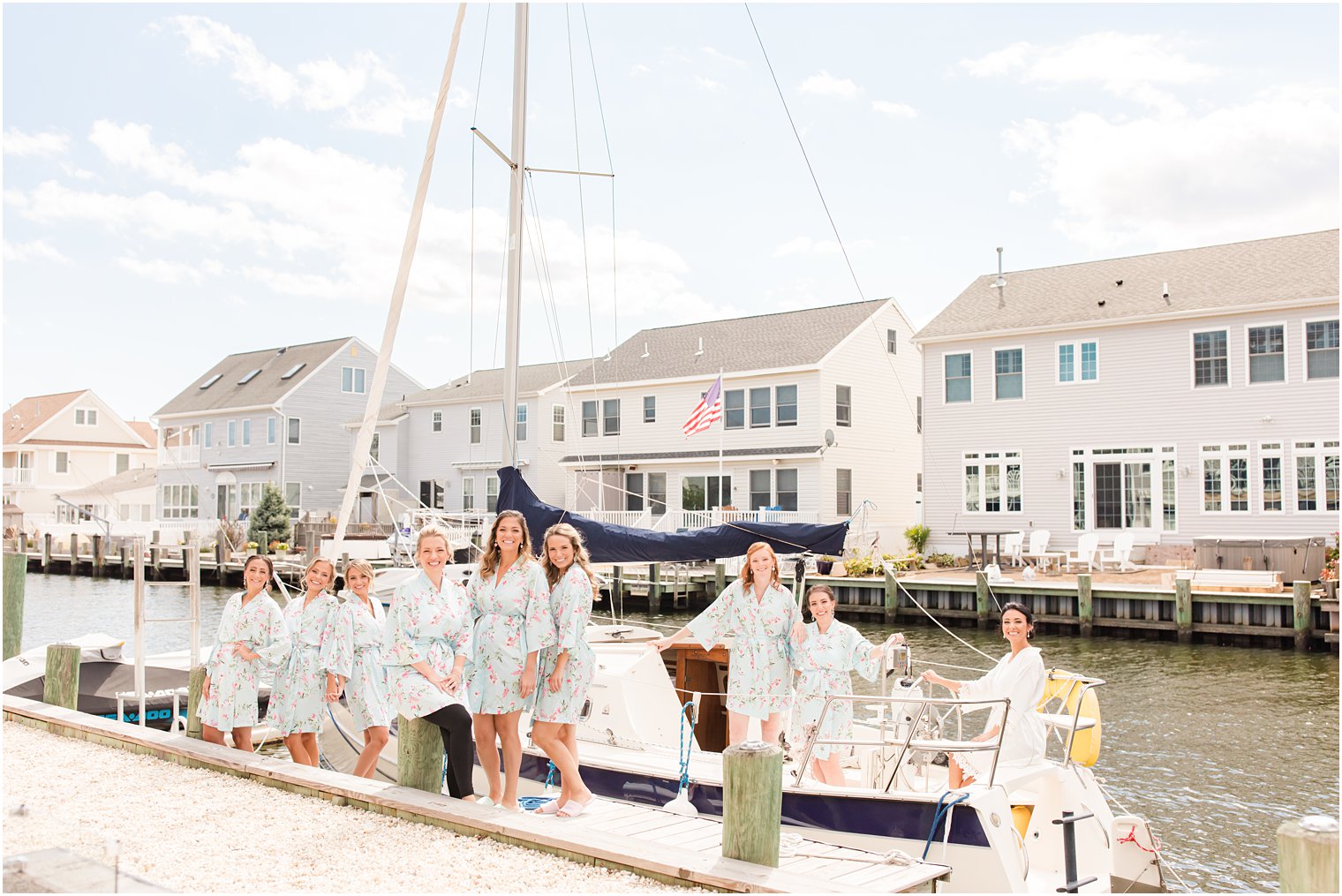bride and bridesmaids pose on boat before NJ wedding day