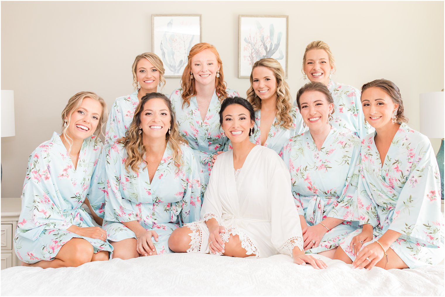 bride sits with bridesmaids in blue robes before NJ wedding