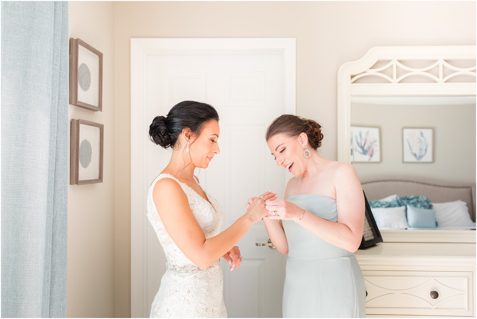 bridesmaid helps bride with bracelet before NJ wedding