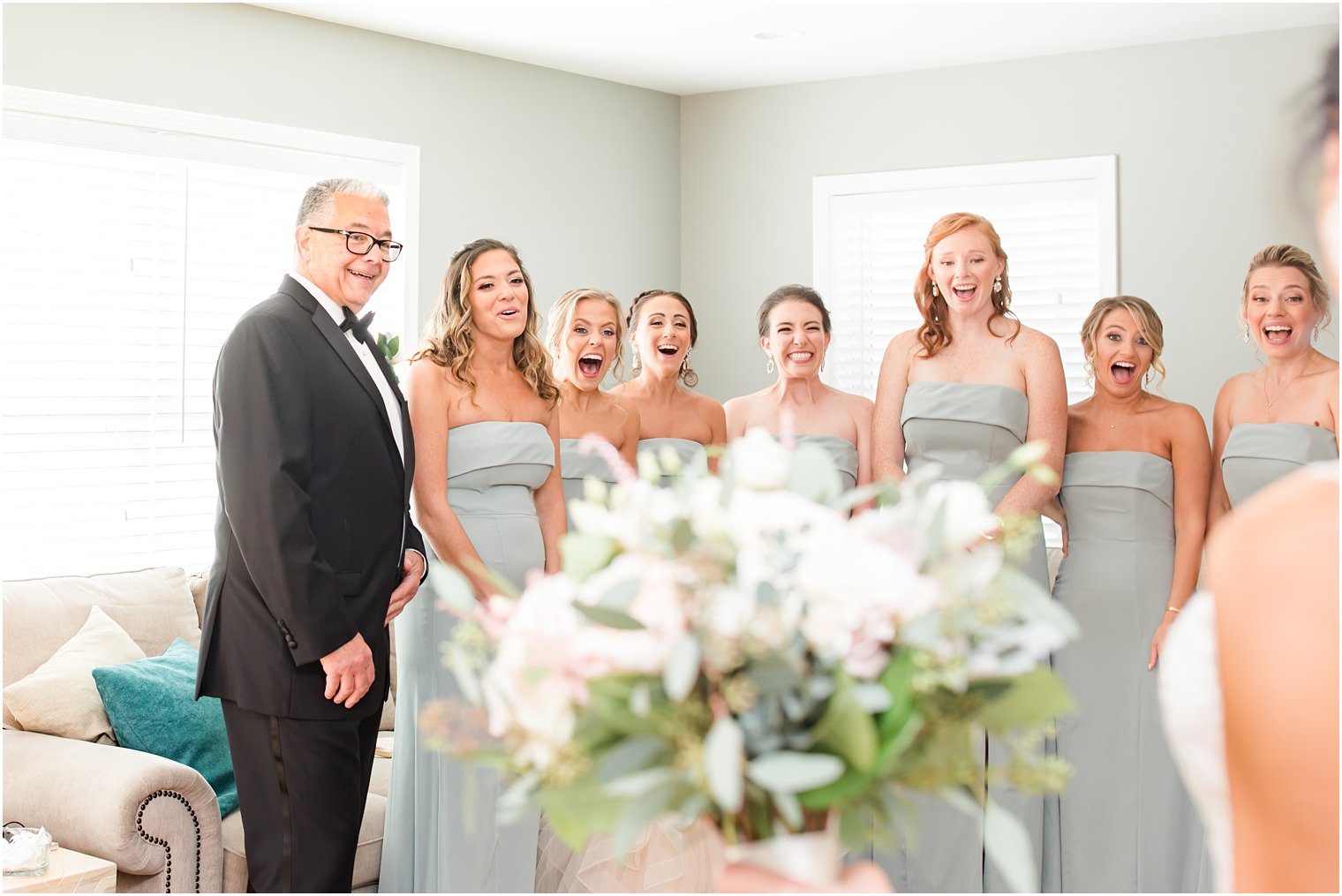bridesmaids have first look with bride and dad