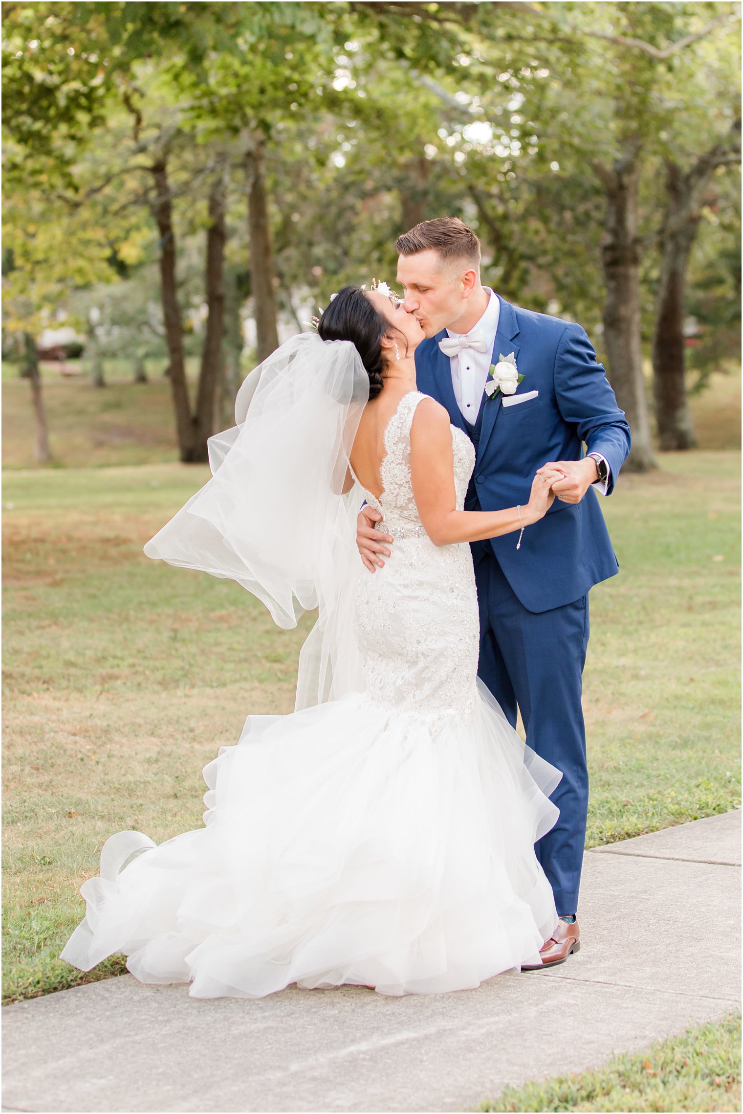newlyweds kiss during New Jersey wedding portraits