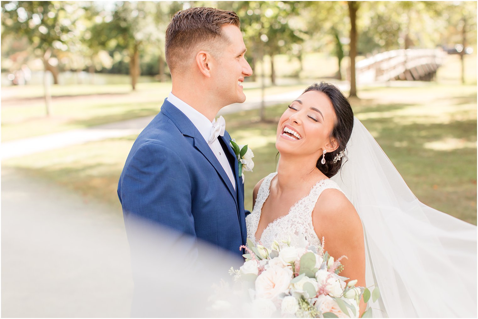 bride laughs while hugging groom on NJ wedding day