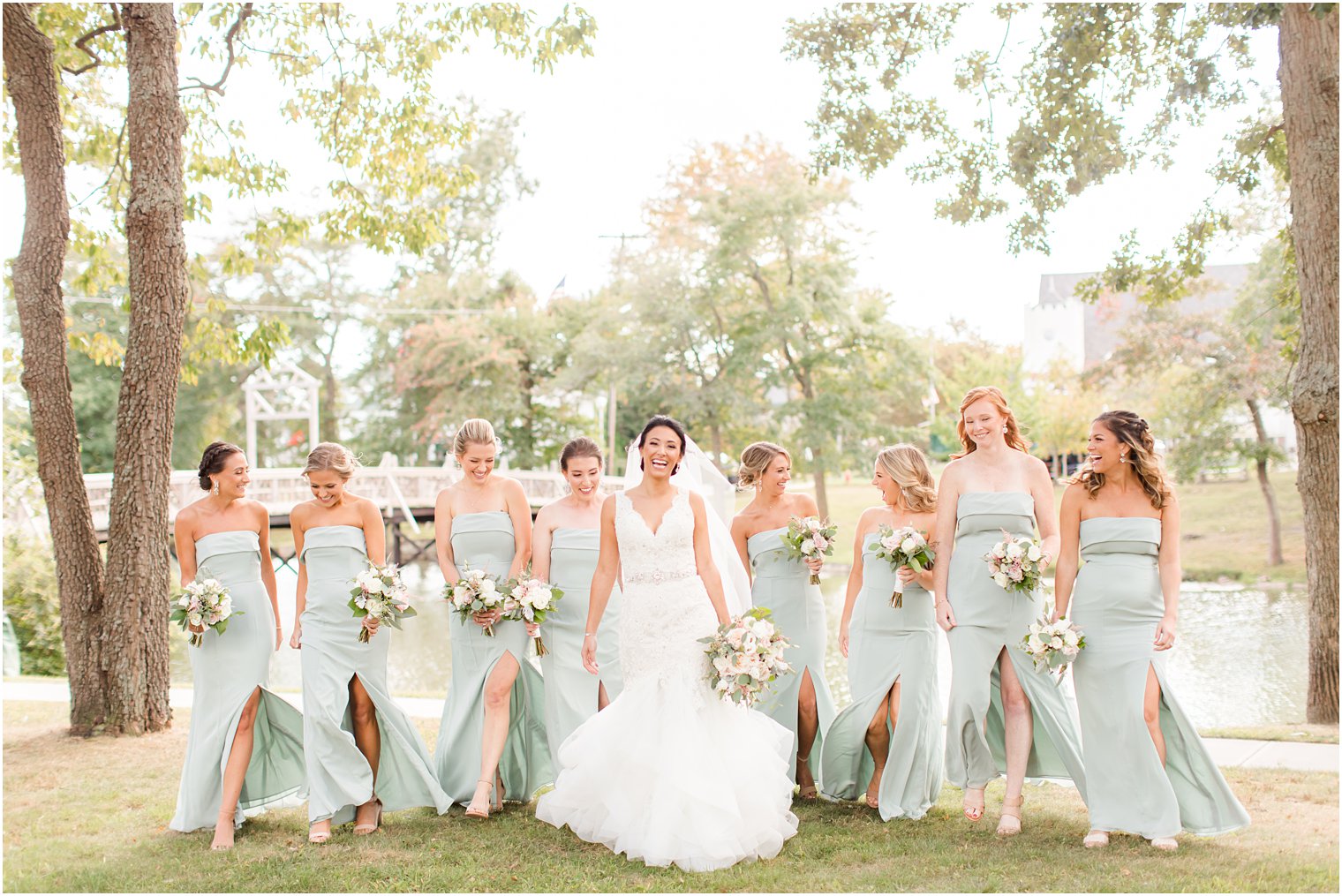 bride walks with bridesmaids in sage green gowns