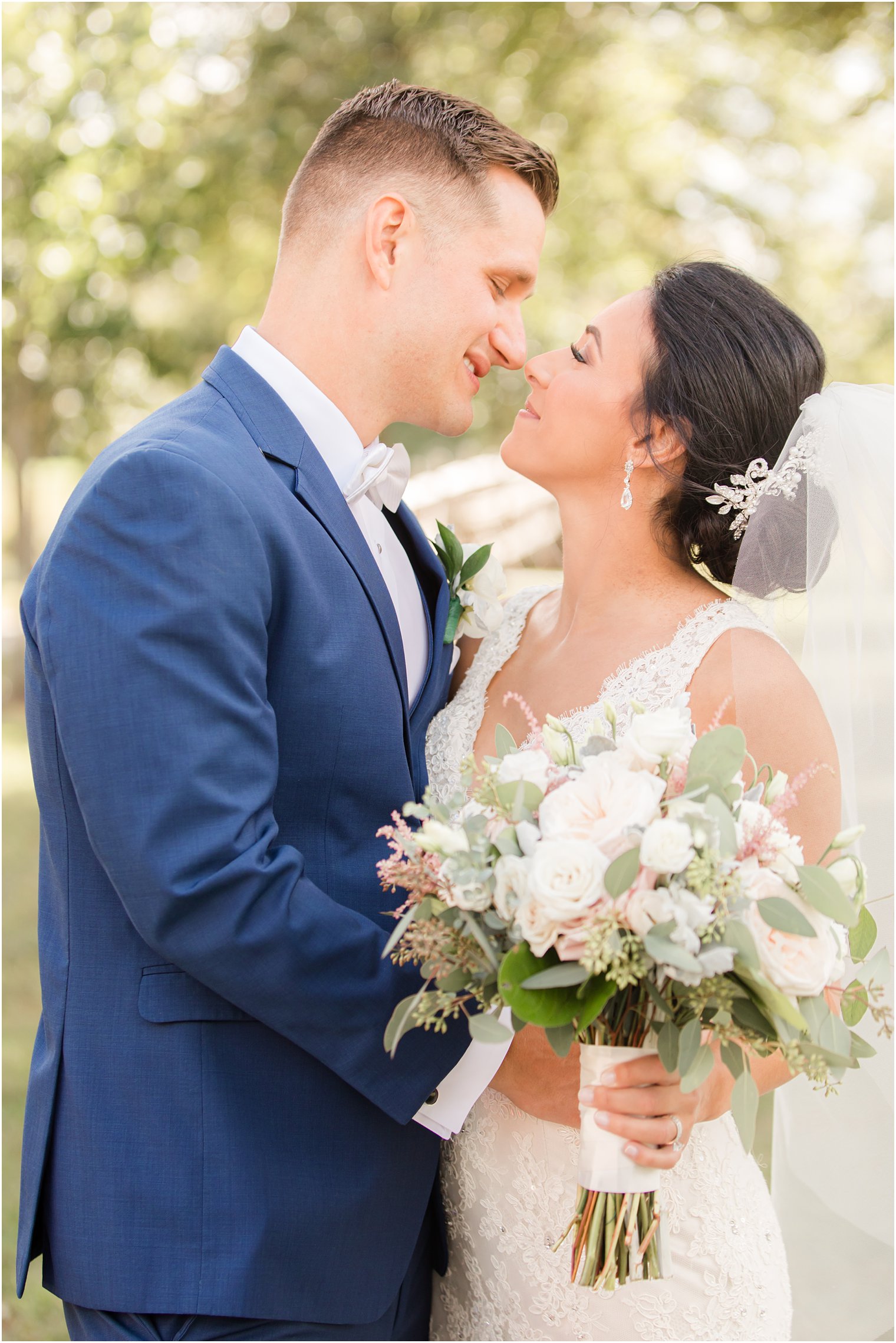 bride and groom touch noses during NJ wedding portraits 
