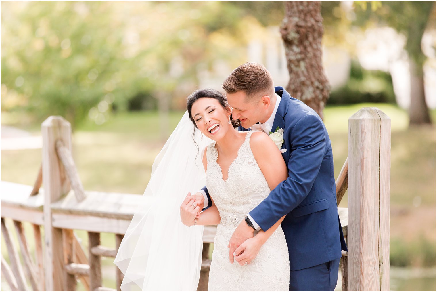 groom makes bride laugh during NJ wedding portraits 
