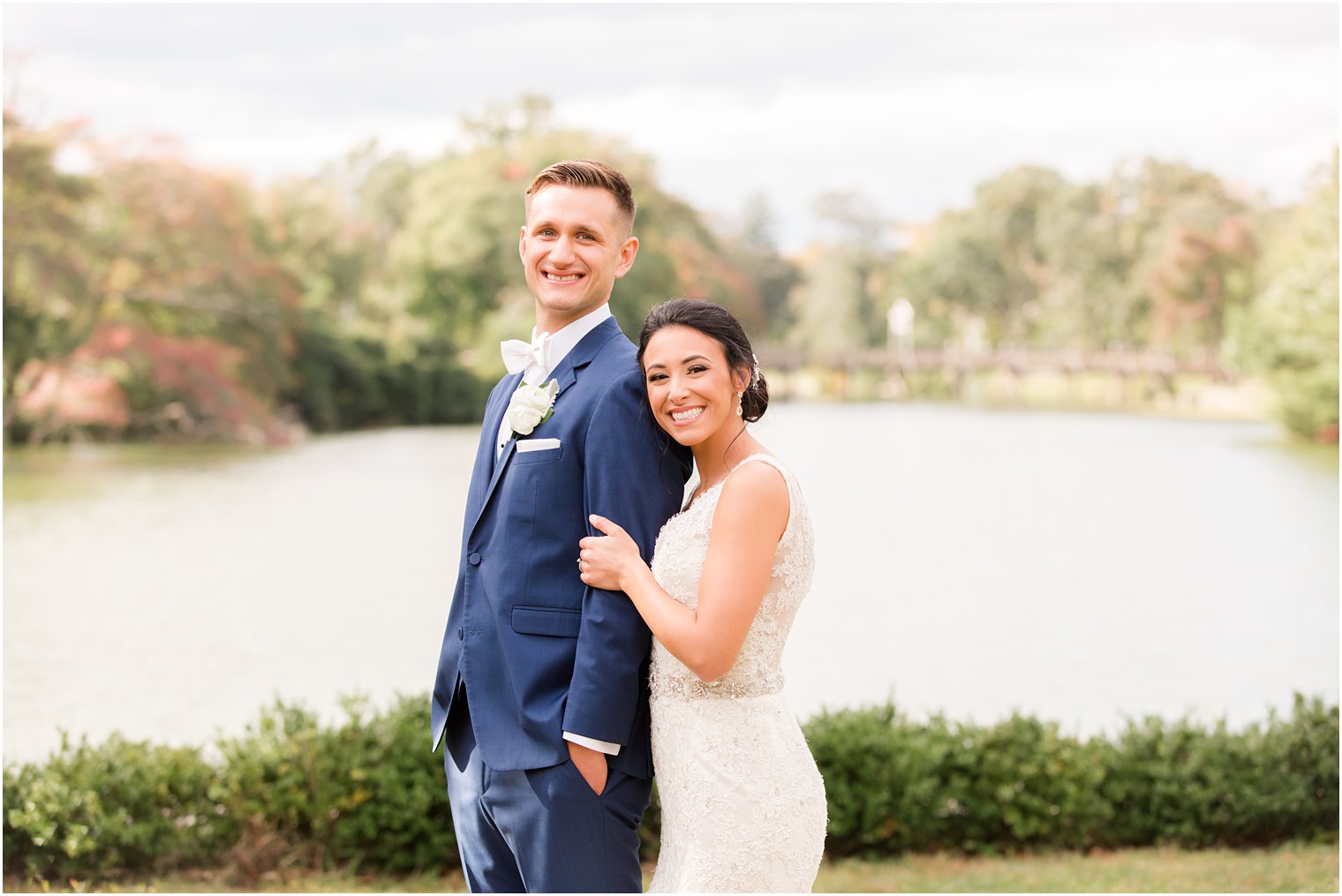 bride hugs groom from behind during NJ wedding portraits 