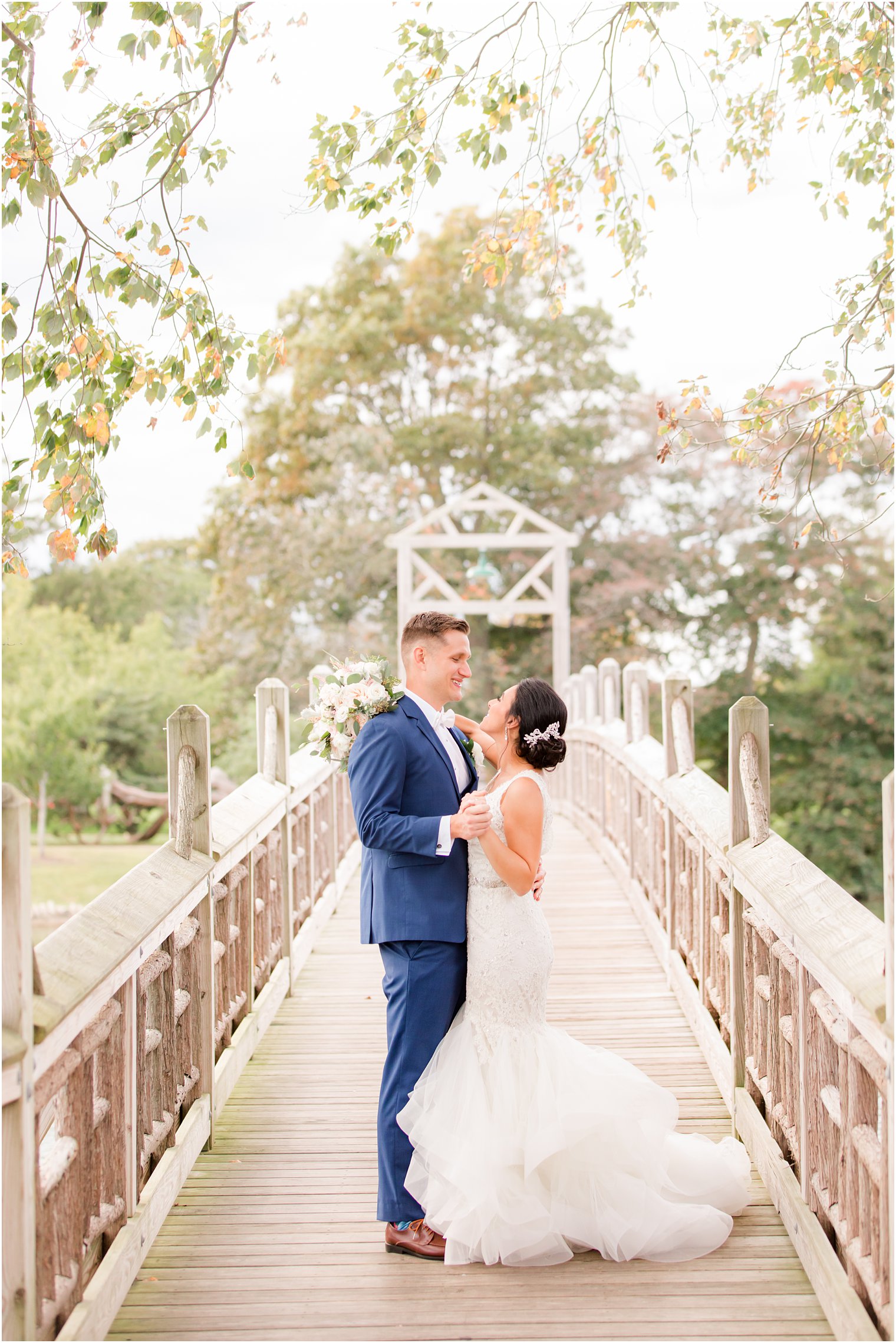 newlyweds dance on wooden bridge in New Jersey 