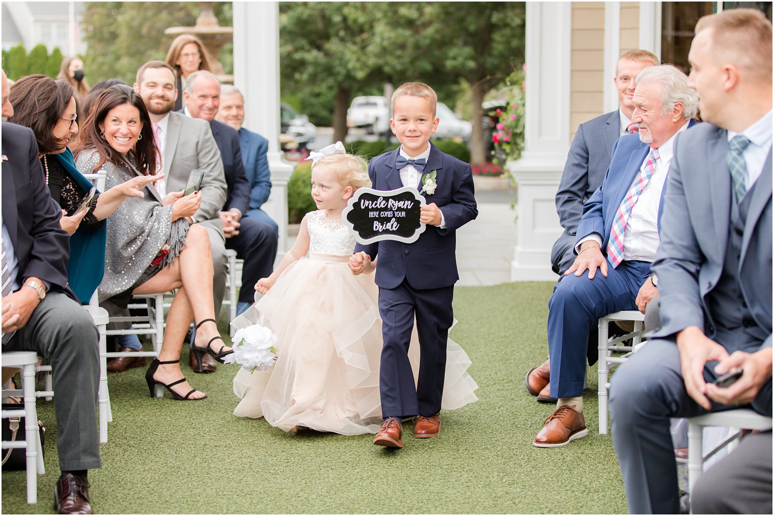 ring bearer and flower girl walk down aisle in New Jersey 